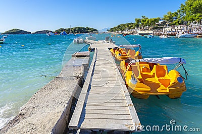 jetty for pleasure boats in the crystal-clear bathing area of â€‹â€‹Bora Bora beach in Ksamil, Albania. Stock Photo